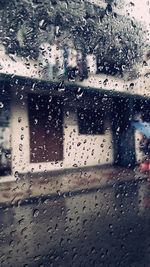 Raindrops on glass window of rainy season