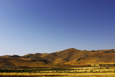 Scenic view of mountains against clear blue sky