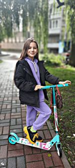 Portrait of young woman walking on road