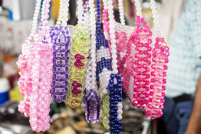 Close-up of colorful ornaments hanging at market