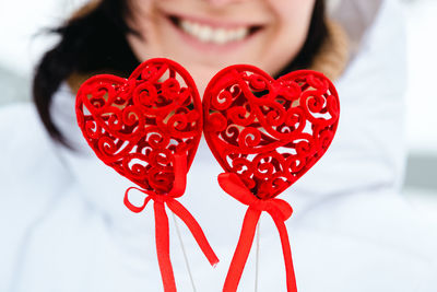 Midsection of woman holding heart shape