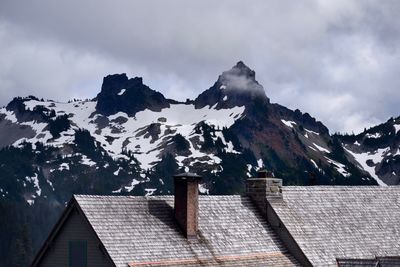 Low angle view of snow covered mountain against sky