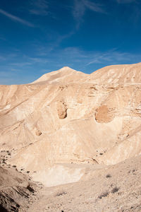 Scenic view of desert against blue sky