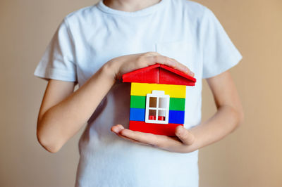 Boy holding toy house