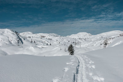 Scenic view of snow mountains against sky