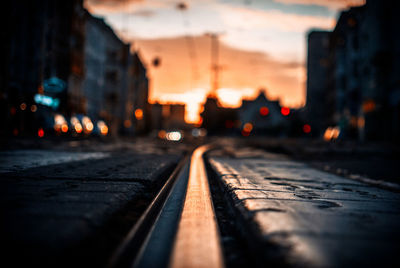 Surface level of tramway on street during sunset in city