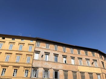 Low angle view of building against clear blue sky