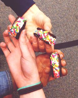 High angle view of man holding multi colored candies