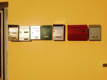 Low angle view of letter boxes on wall