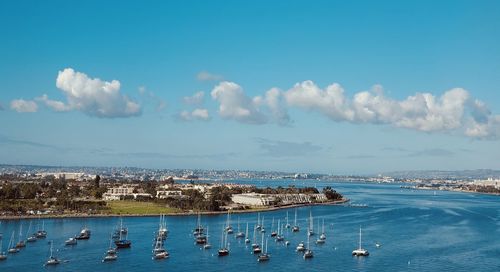 Sailboats in sea against sky