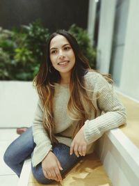 Thoughtful young woman sitting on seat