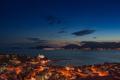 Aerial view of illuminated sea against sky at night