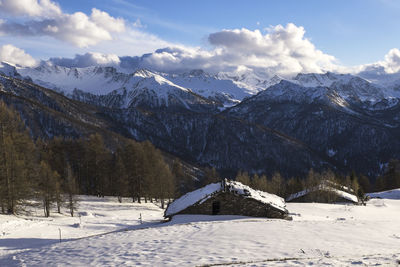 Scenic view of snow covered mountains against sky