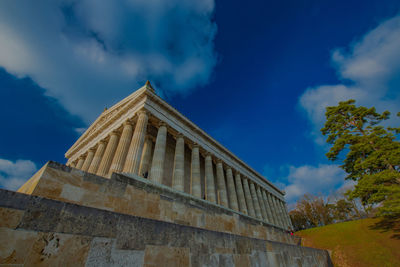 Low angle view of historical building against cloudy sky