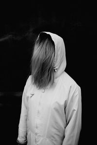 Woman wearing hooded shirt at night