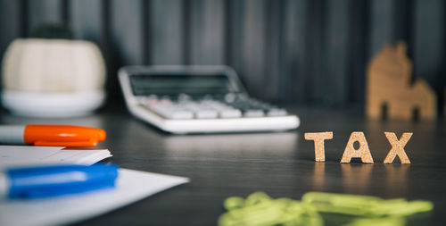 Close-up of text and calculator on table