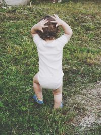 Full length of girl standing on field