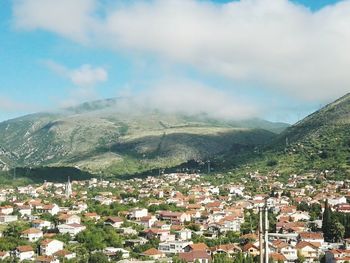 High angle view of houses and mountains against sky