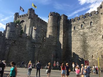 Tourists at castle on sunny day