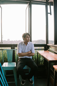 Side view of young man using mobile phone