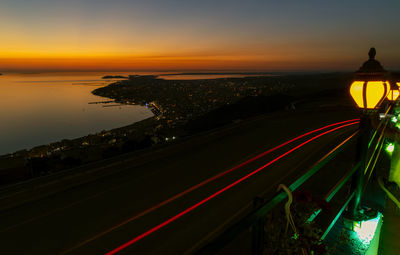 High angle view of light trails on road at sunset