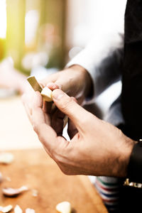 Close-up of hand holding cigarette