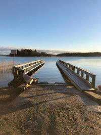 Pier over lake against sky