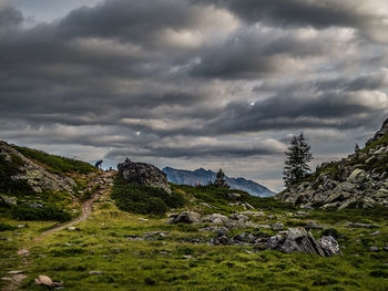 Scenic view of mountains against cloudy sky