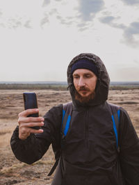 Traveler hiker photographer man  smartphone backpack walking taking picture active lifestyle travel 