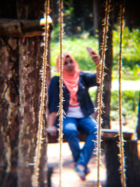 Close-up of girl hanging on swing