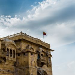 Low angle view of building against cloudy sky