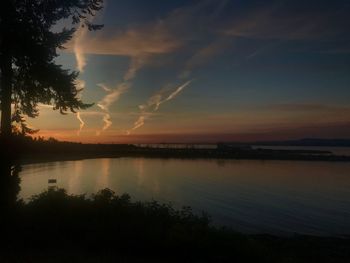 Scenic view of silhouette trees against sky at sunset