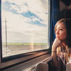 Woman looking through train window