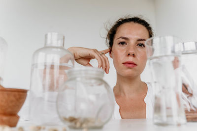 Portrait of young woman holding bottle