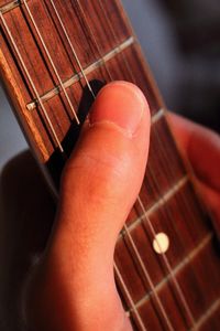 Cropped hand playing guitar