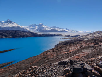 Scenic view of snowcapped mountains against clear blue sky