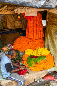 Man for sale at market stall