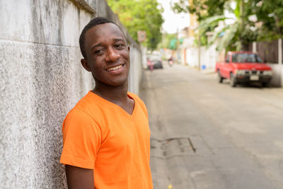 Portrait of smiling man standing on street in city