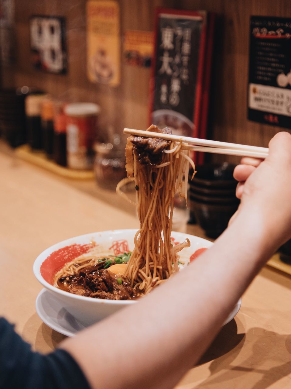 human hand, hand, holding, real people, food, food and drink, human body part, one person, lifestyles, leisure activity, indoors, chopsticks, freshness, selective focus, women, bowl, adult, table, unrecognizable person, finger, japanese food