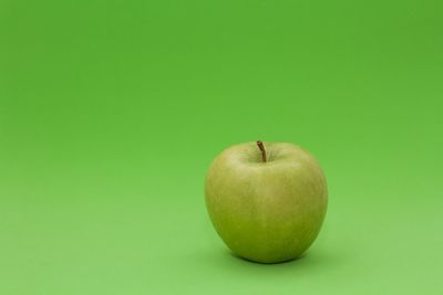 Close-up of apple on green background