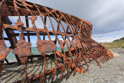 Old rusty metallic structure against sky