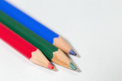 Close-up of colored pencils against white background