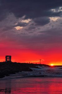 Scenic view of beach against sky during sunset