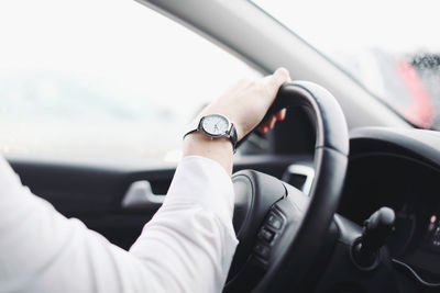 Cropped image of woman driving car