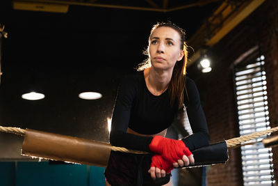 Portrait of young man exercising in gym