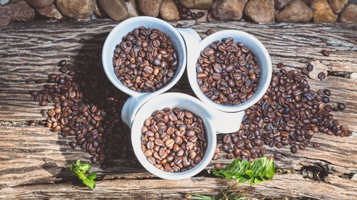 High angle view of roasted coffee beans in cups