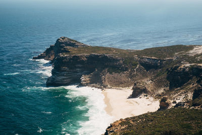 Scenic view of cliff by sea