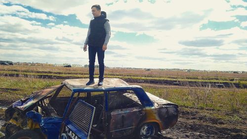 Full length of man standing on field against sky