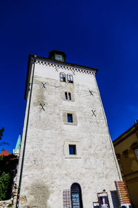 Low angle view of old building against blue sky