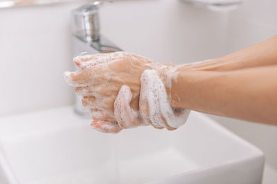 Cropped hand of woman cleaning hands